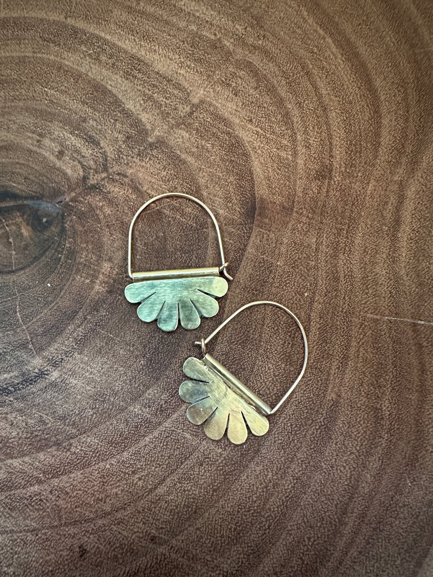 The Naupaka Flower Hoop Earrings swinging